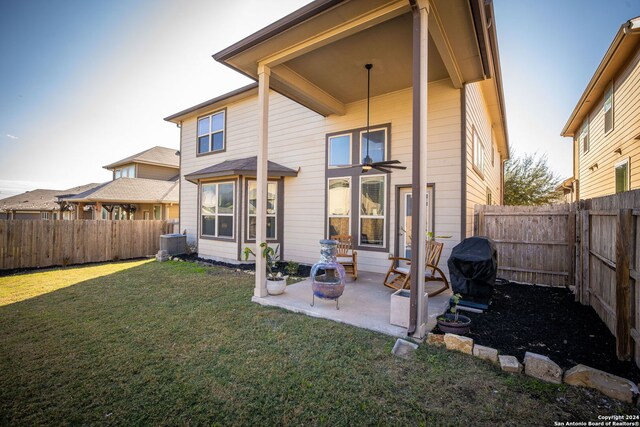 back of house with a patio, a lawn, and central air condition unit