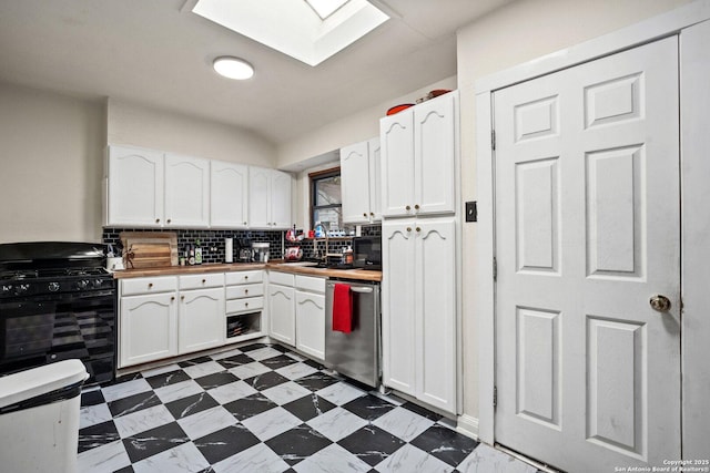 kitchen with a skylight, stainless steel dishwasher, white cabinets, black gas stove, and butcher block countertops