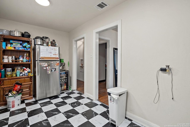 interior space featuring stainless steel fridge and wine cooler