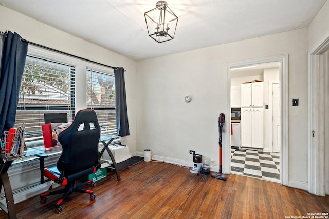 office area with a notable chandelier and dark hardwood / wood-style floors