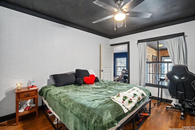 bedroom featuring wood-type flooring, ceiling fan, and ornamental molding