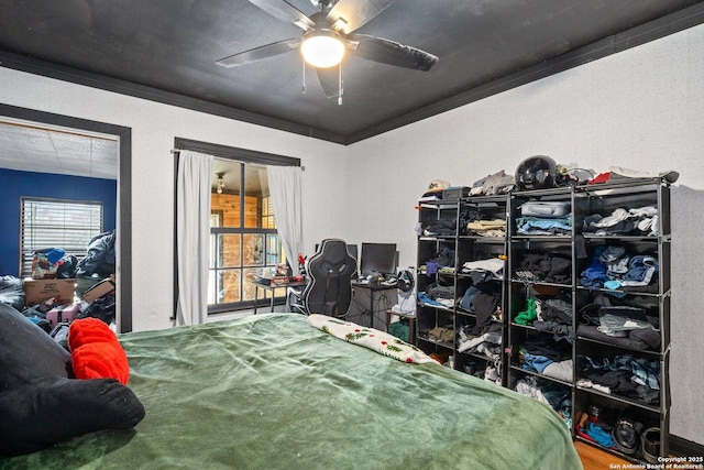 bedroom with ceiling fan and ornamental molding