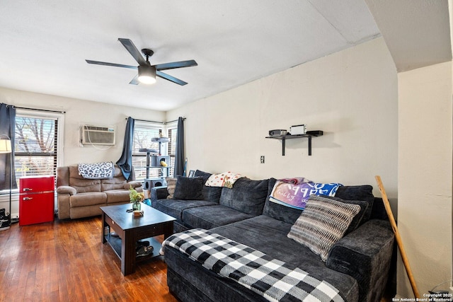 living room with an AC wall unit, ceiling fan, and dark hardwood / wood-style flooring