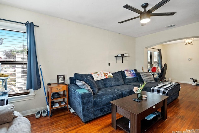 living room featuring dark hardwood / wood-style floors and ceiling fan