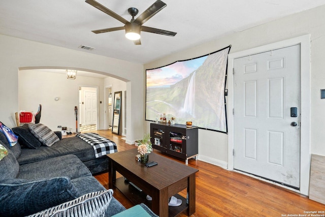 living room featuring hardwood / wood-style floors and ceiling fan