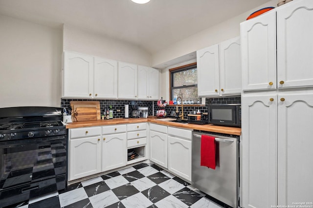 kitchen with butcher block countertops, sink, white cabinets, and black appliances