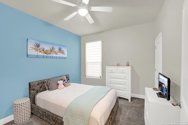 bedroom featuring ceiling fan and dark carpet