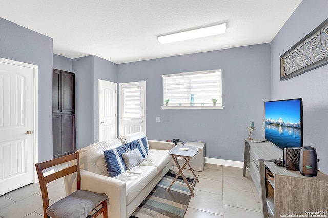 tiled living room with a textured ceiling