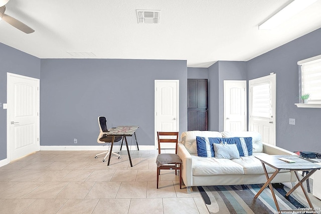 tiled living room featuring ceiling fan