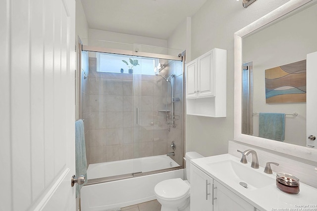 full bathroom featuring tile patterned floors, vanity, enclosed tub / shower combo, and toilet