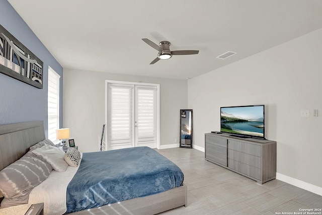 bedroom with ceiling fan and multiple windows