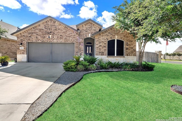 view of front facade with a front yard and a garage