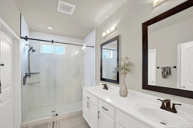 bathroom featuring tile patterned flooring, vanity, and an enclosed shower