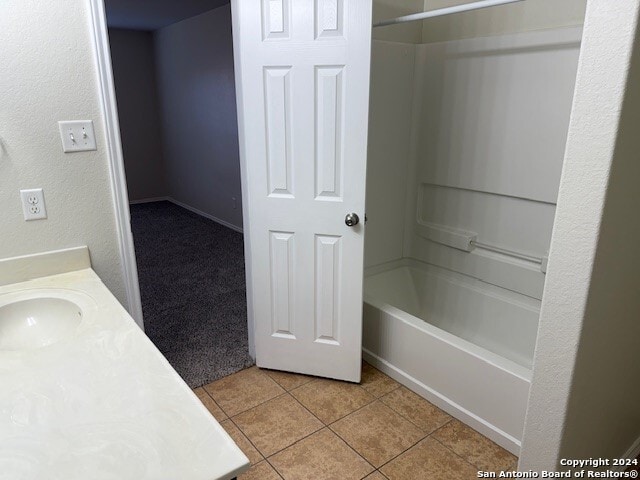 bathroom with tile patterned flooring, vanity, and shower / bathtub combination