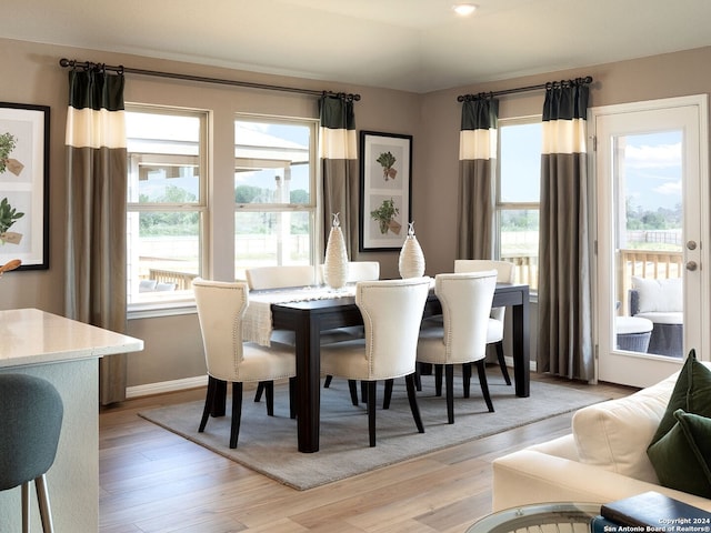 dining space featuring plenty of natural light and light hardwood / wood-style floors