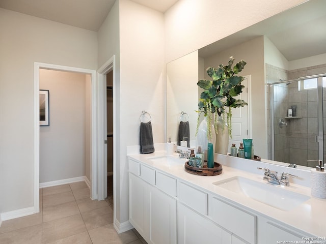 bathroom with tile patterned floors, vanity, and an enclosed shower