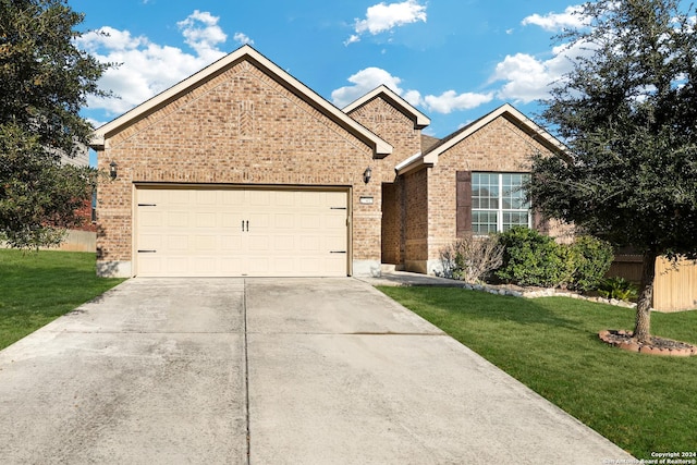 view of front of house with a garage and a front lawn