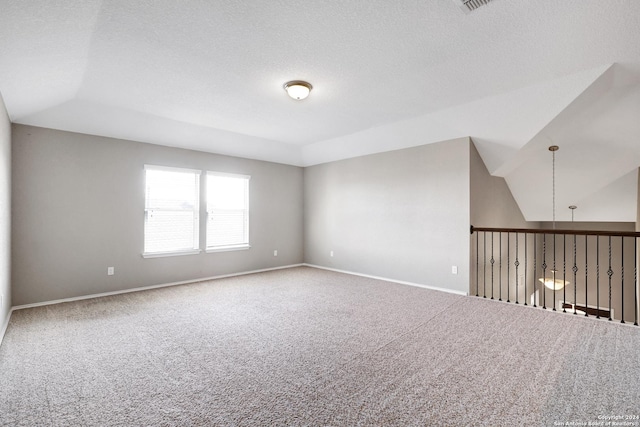 spare room featuring lofted ceiling and carpet floors