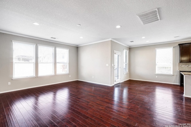 unfurnished living room with a textured ceiling, dark hardwood / wood-style floors, crown molding, and a wealth of natural light