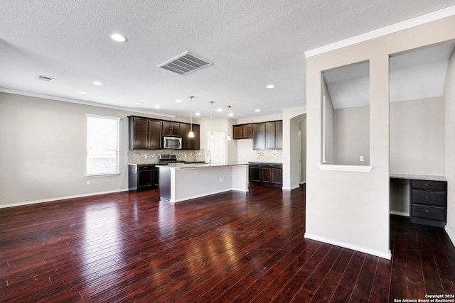 kitchen with stainless steel appliances, tasteful backsplash, a kitchen island, and pendant lighting