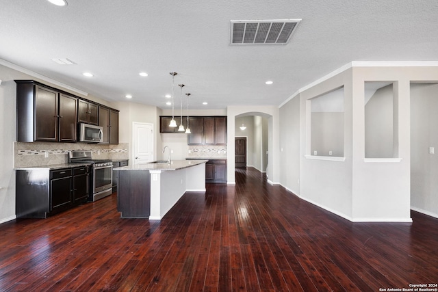 kitchen featuring light stone countertops, an island with sink, pendant lighting, appliances with stainless steel finishes, and ornamental molding