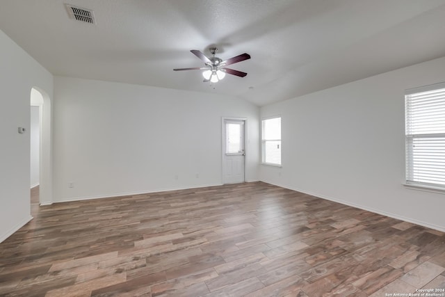 empty room featuring hardwood / wood-style floors, ceiling fan, and lofted ceiling