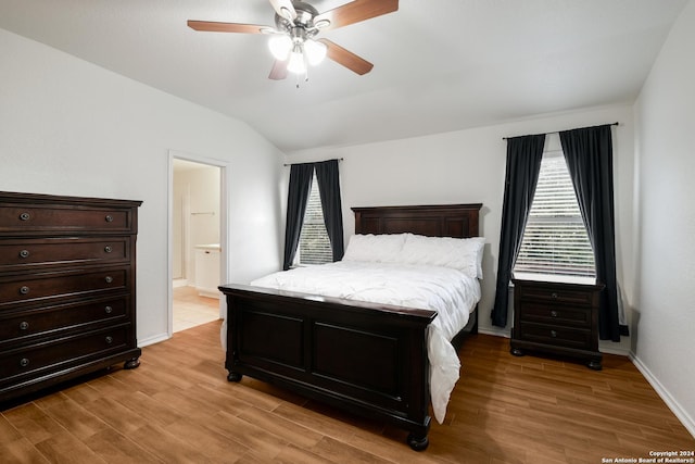 bedroom featuring connected bathroom, ceiling fan, light hardwood / wood-style floors, and lofted ceiling