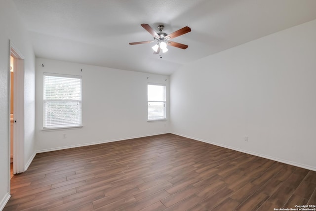 unfurnished room with ceiling fan, dark wood-type flooring, and a wealth of natural light