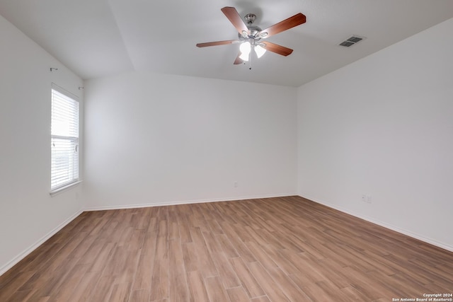 empty room featuring ceiling fan, light hardwood / wood-style floors, and lofted ceiling