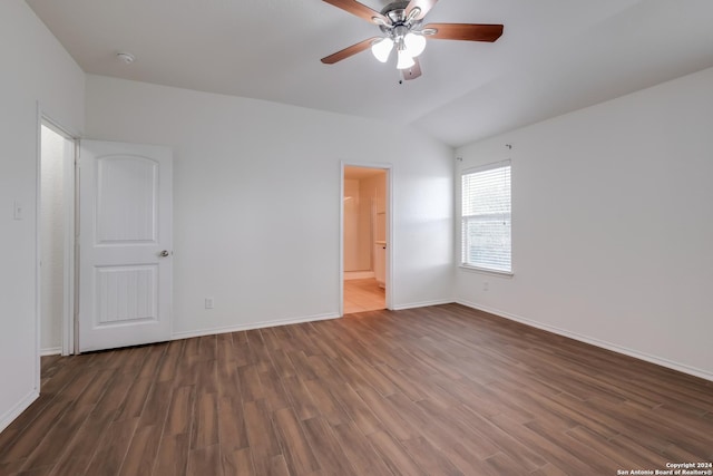 spare room with dark hardwood / wood-style floors, ceiling fan, and lofted ceiling