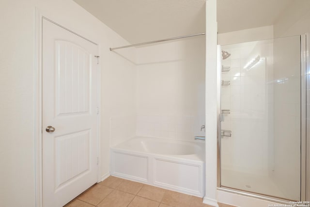 bathroom featuring tile patterned flooring and separate shower and tub