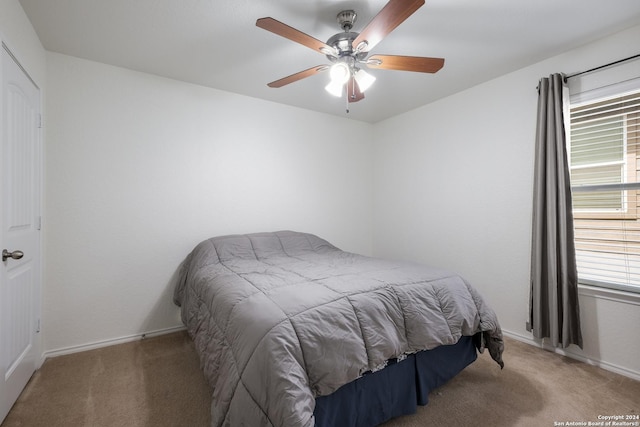 carpeted bedroom featuring ceiling fan