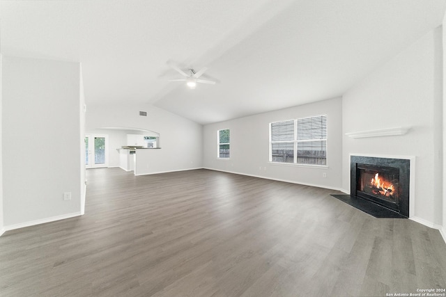 unfurnished living room featuring ceiling fan, dark hardwood / wood-style flooring, and lofted ceiling