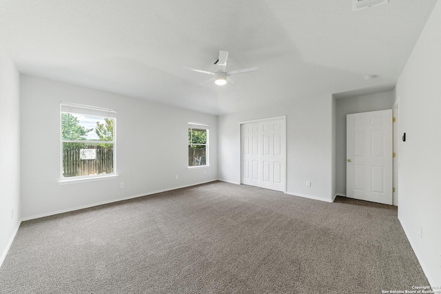 unfurnished bedroom featuring ceiling fan, carpet floors, and a closet