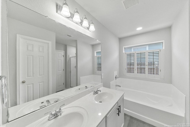 bathroom featuring vanity and a tub