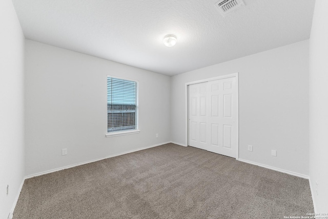 unfurnished bedroom featuring carpet flooring and a closet