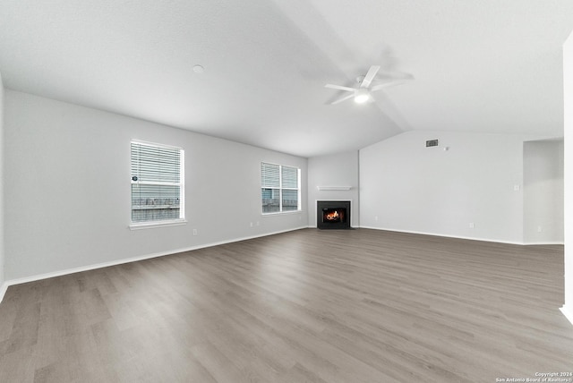 unfurnished living room featuring ceiling fan, light hardwood / wood-style flooring, and lofted ceiling