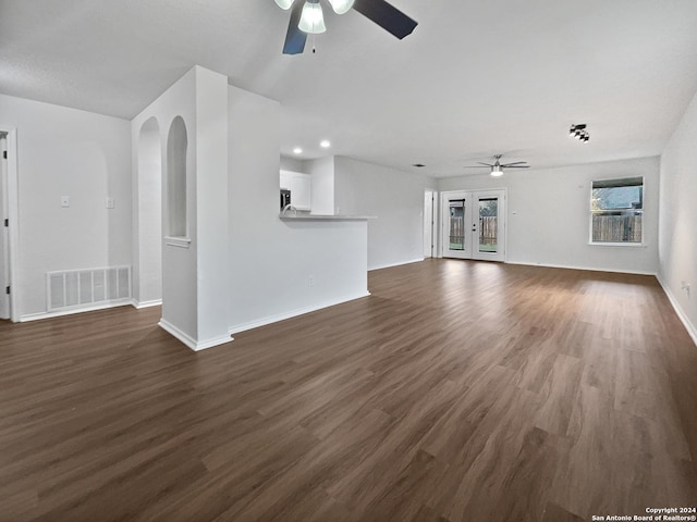 unfurnished living room with ceiling fan and dark hardwood / wood-style floors