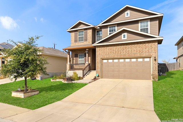 craftsman-style house featuring a porch, a front yard, and a garage