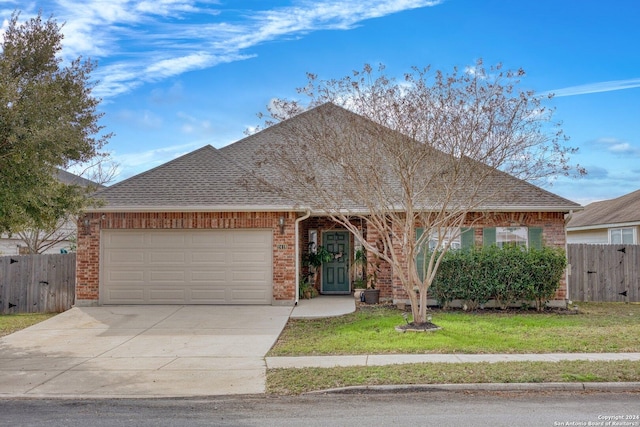 single story home with a garage and a front lawn