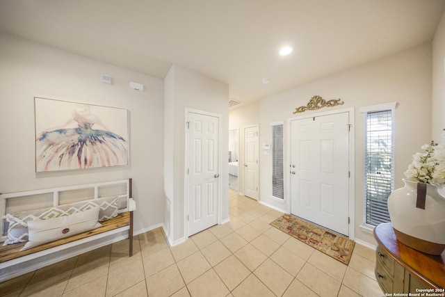 foyer entrance with light tile patterned floors