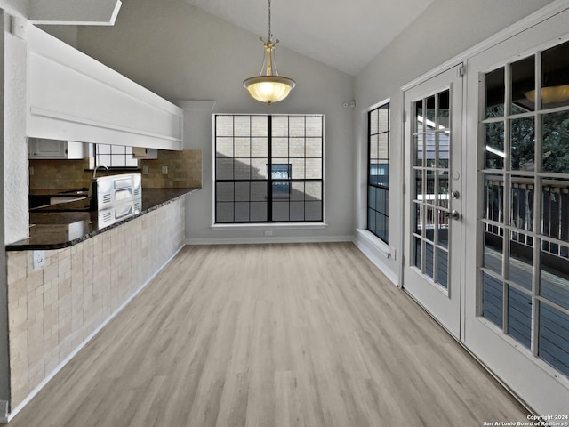 interior space featuring light hardwood / wood-style floors, vaulted ceiling, and sink