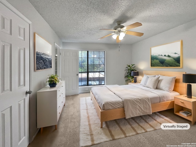 carpeted bedroom with a textured ceiling, access to outside, and ceiling fan