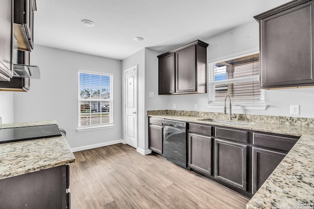 kitchen featuring light stone counters, dark brown cabinetry, sink, light hardwood / wood-style flooring, and black dishwasher