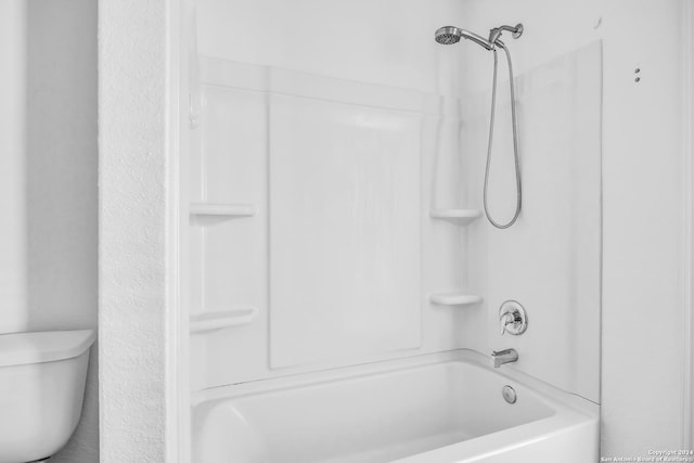 bathroom featuring toilet and shower / bathtub combination