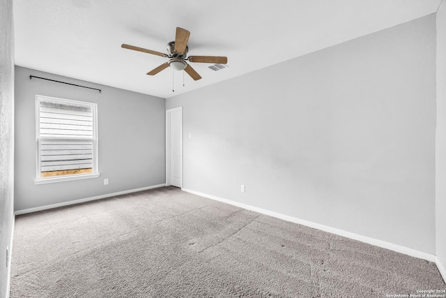 unfurnished room featuring ceiling fan and carpet floors