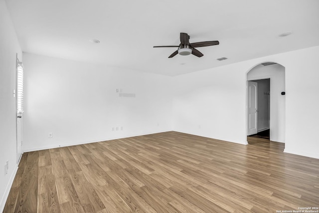 empty room with light wood-type flooring and ceiling fan