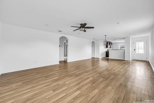 unfurnished living room with ceiling fan and light hardwood / wood-style floors