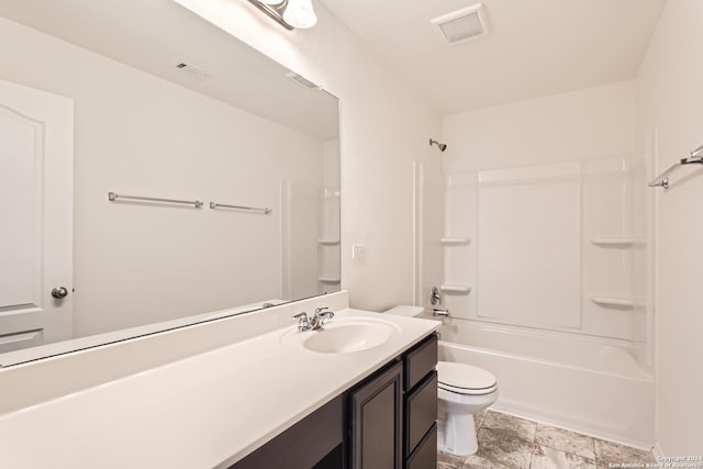 full bathroom featuring toilet, vanity, and tub / shower combination