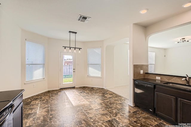 kitchen featuring pendant lighting, dishwasher, dark brown cabinetry, and sink